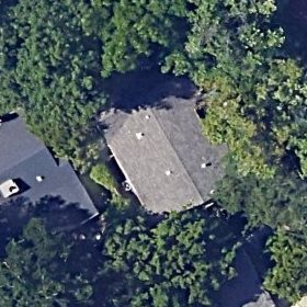 Aerial photograph of a house in Chico, California under heavy tree cover.