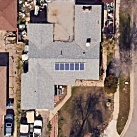 Aerial photograph of a house in Lancaster, California with an open roof.